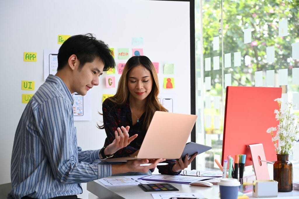 User experience designers team are brainstorming and planning sketch, prototype, framework, layout app design project at office. | User experience process