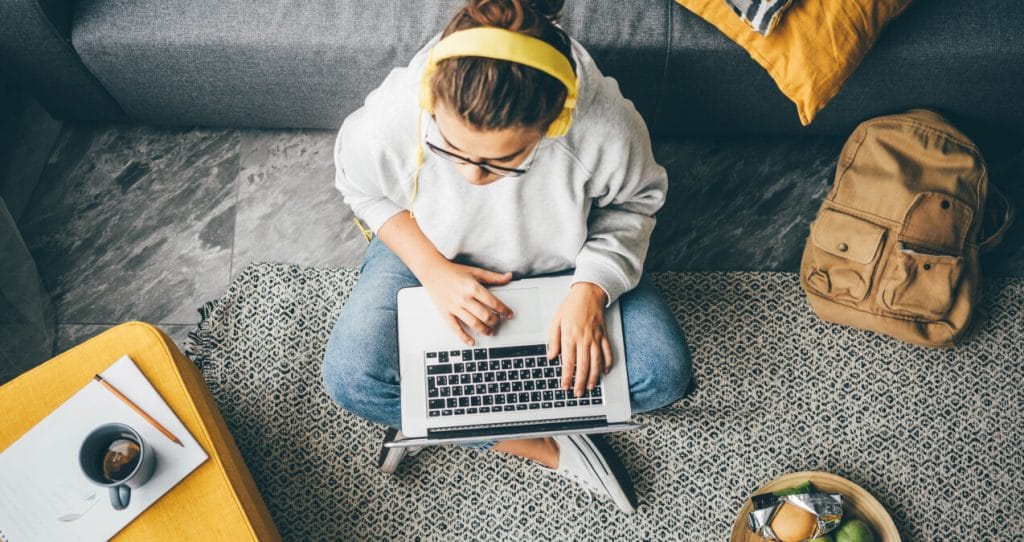 Young woman using laptop computer at home | Ethical data scraping