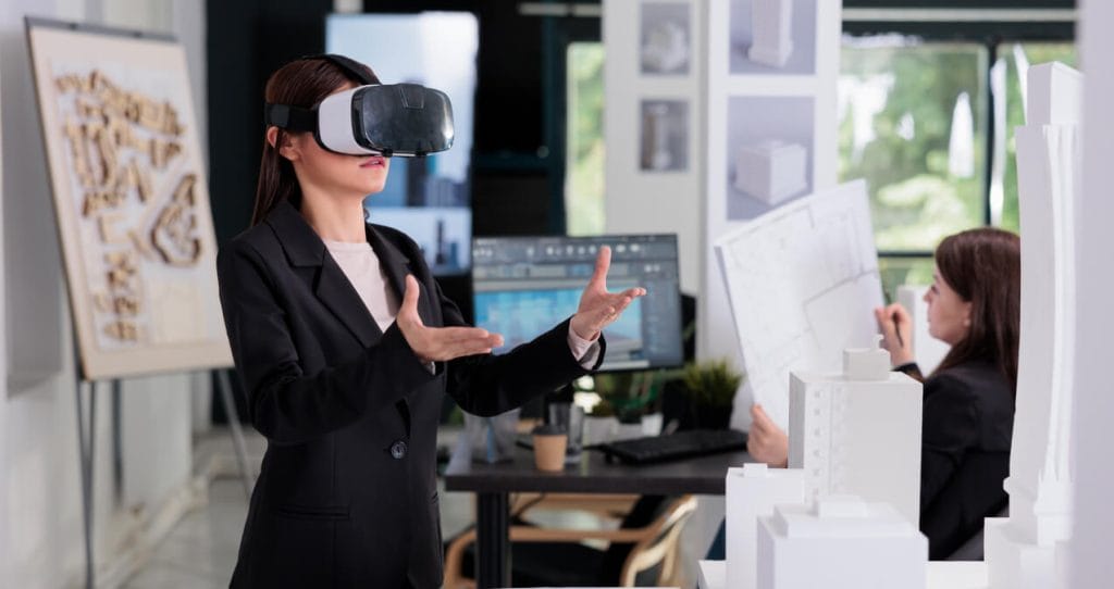 Architect in ar helmet working on architectural project in augmented reality, touching virtual building. | 2023 Website Development Trends
