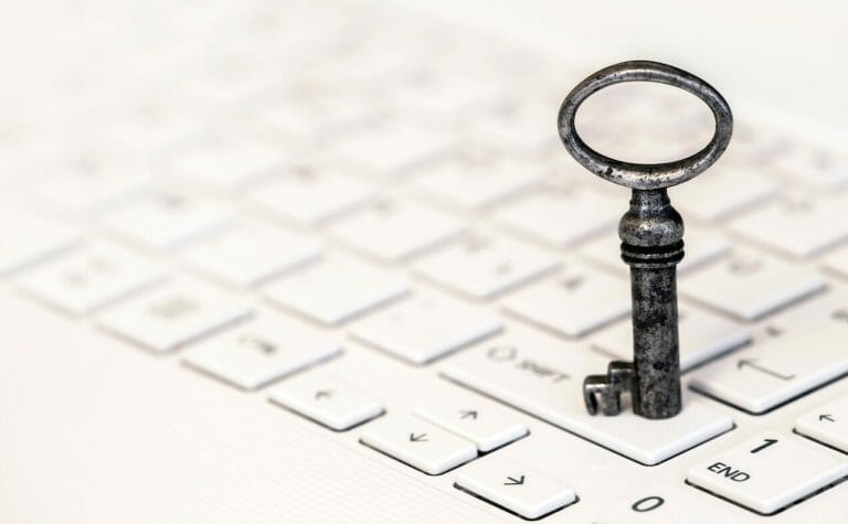 Key standing on a white laptop - web banner of business success and solution concept | SEO Website Optimization