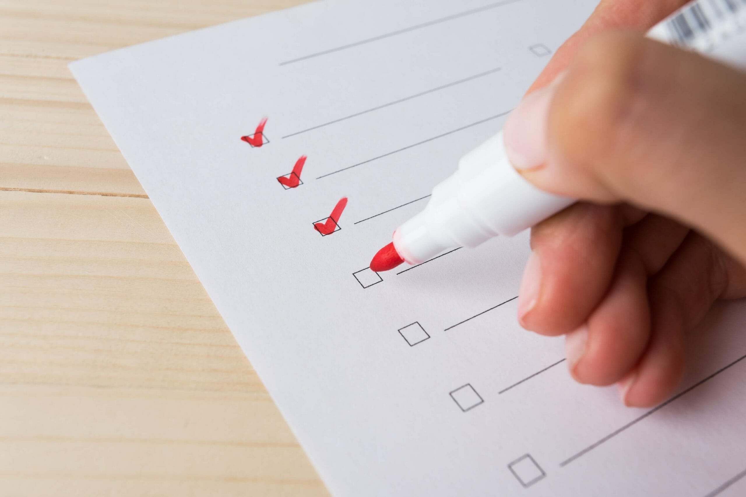 Writing a to list with a red marker | Q4 SEO Checklist for companies