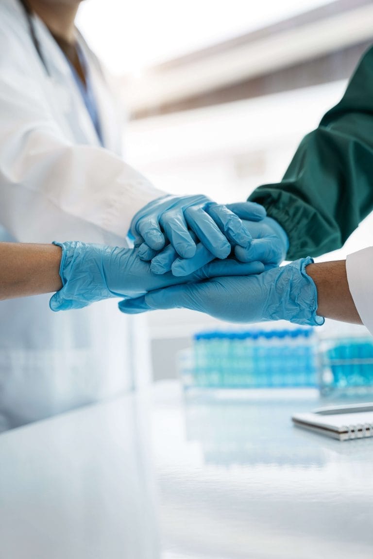 Doctors shaking hands in unity at the hospital | Excel Medical Group SEO project